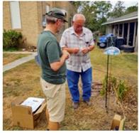 Our team setting up a passive sampler at a community volunteer's yard.